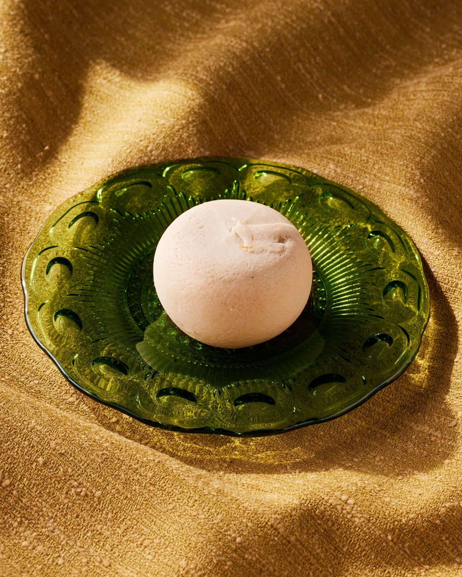 Taiwanese pineapple cake from Little Moon Bakehouse gluten free on a green plate with a gold cloth in the background